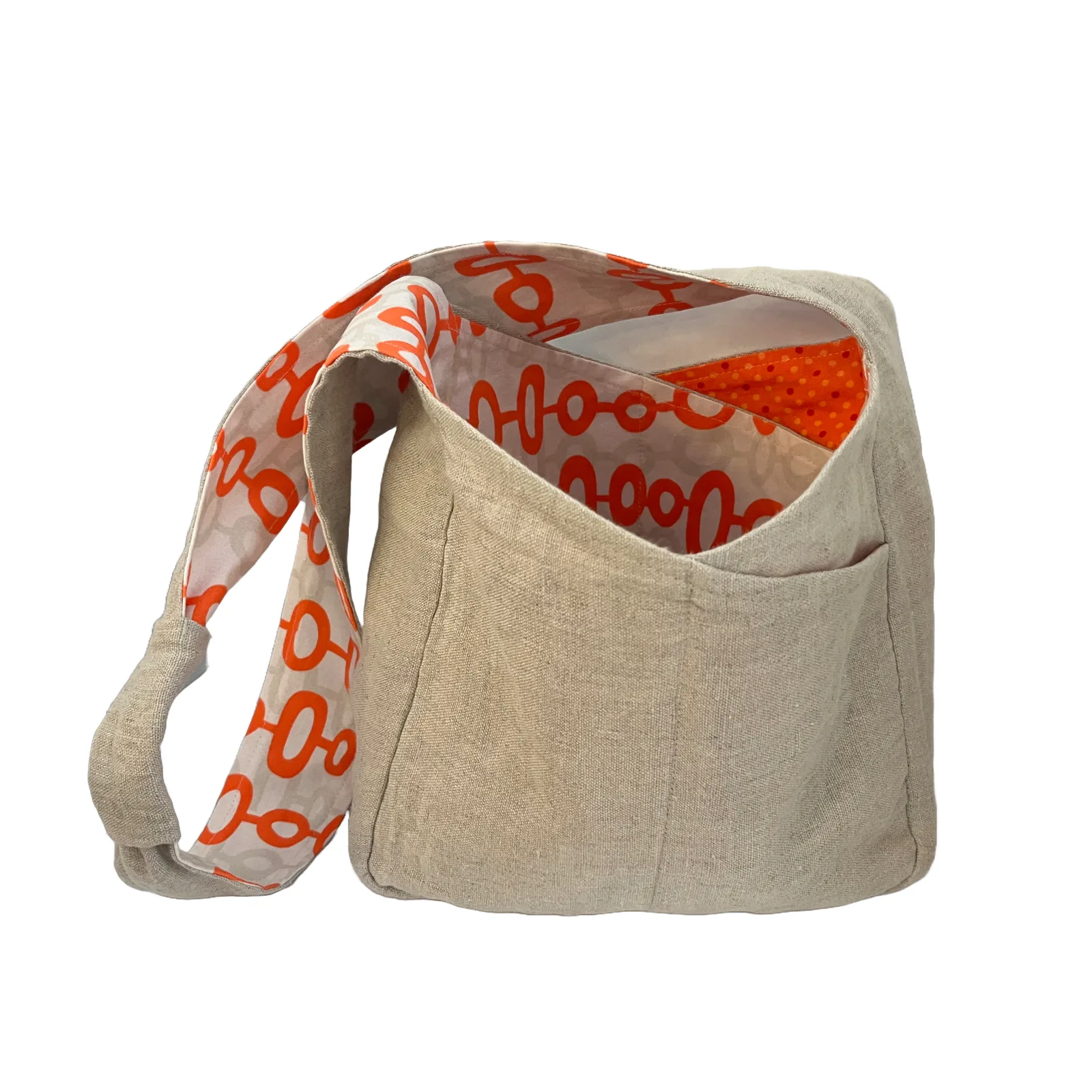 Beige fabric bag with an orange patterned strap on a white background