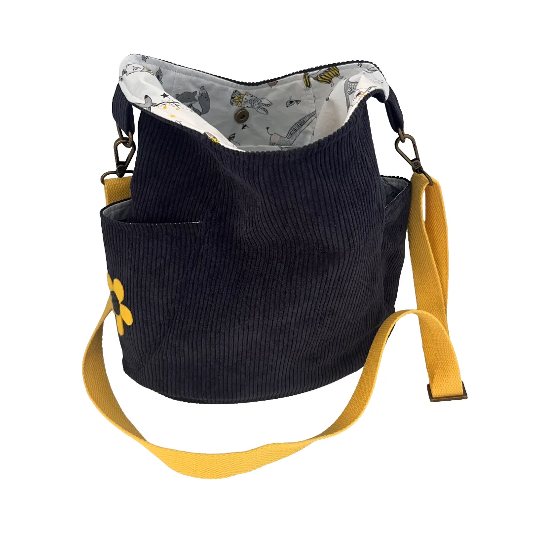 Blue corduroy bag with yellow strap on a white background