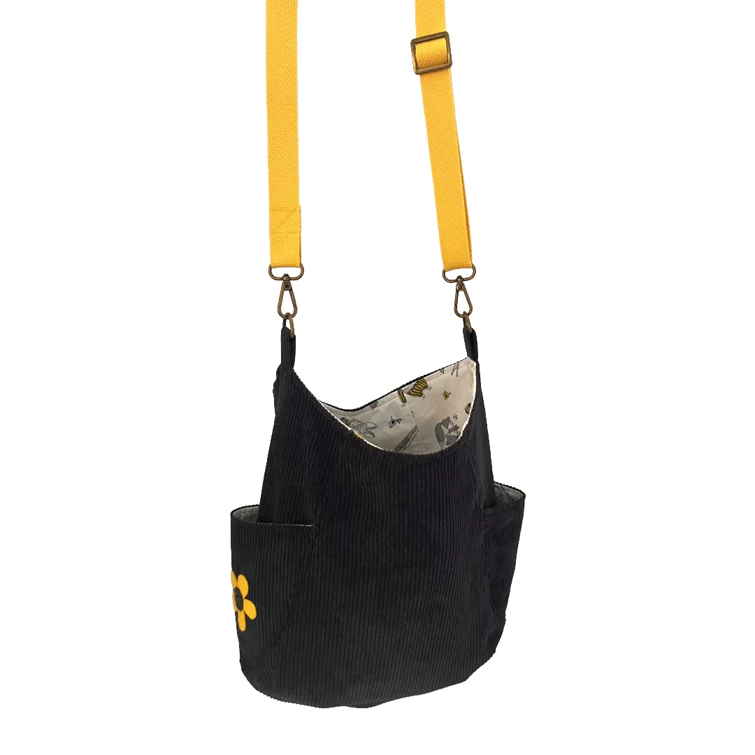 Blue corduroy bag with a strap on a white background
