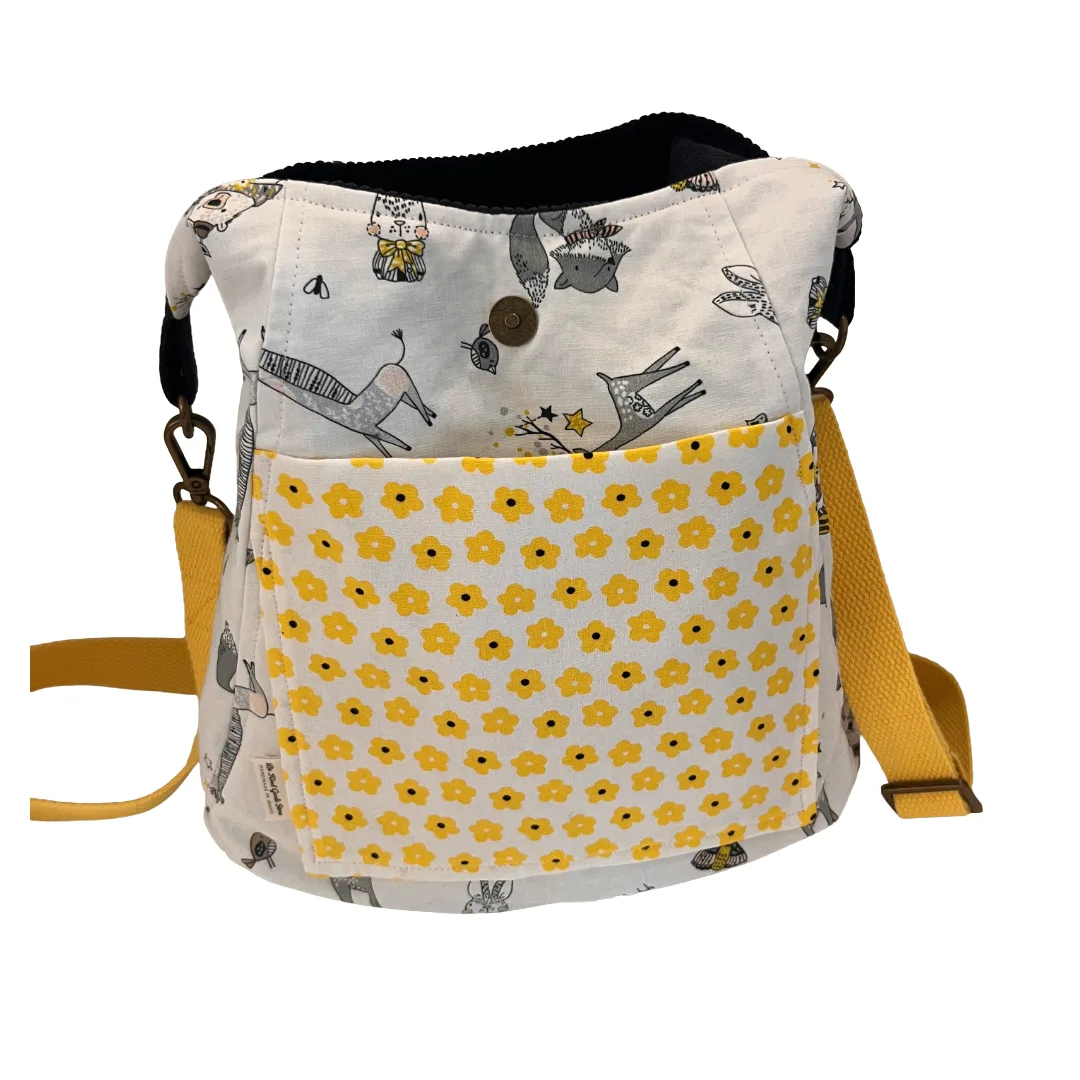Fabric bag with yellow flower pattern and animal illustrations on a white background