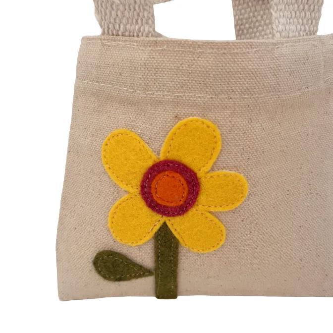 Beige fabric bag with a yellow flower design on a white background