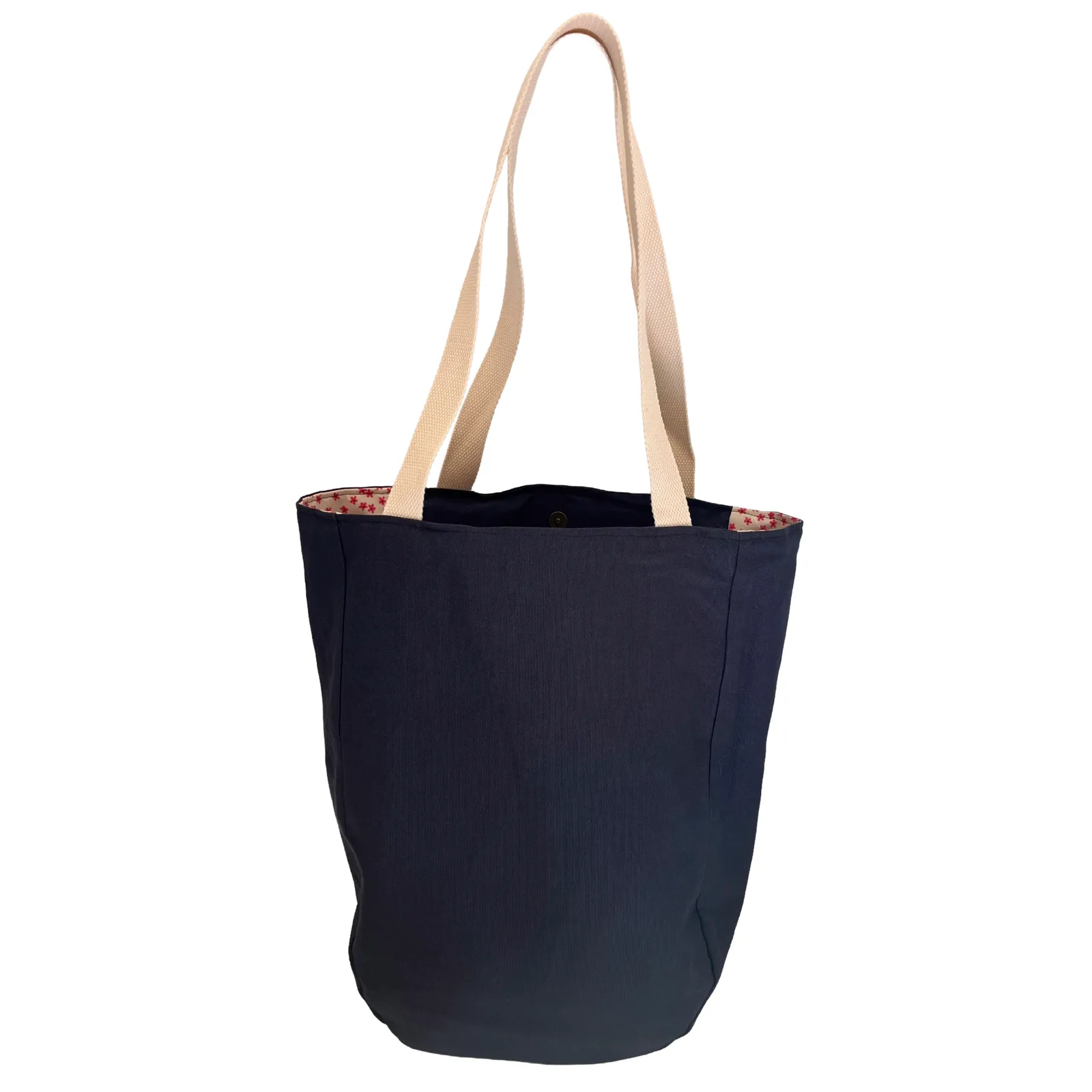 Navy tote bag with cream handles on a white background