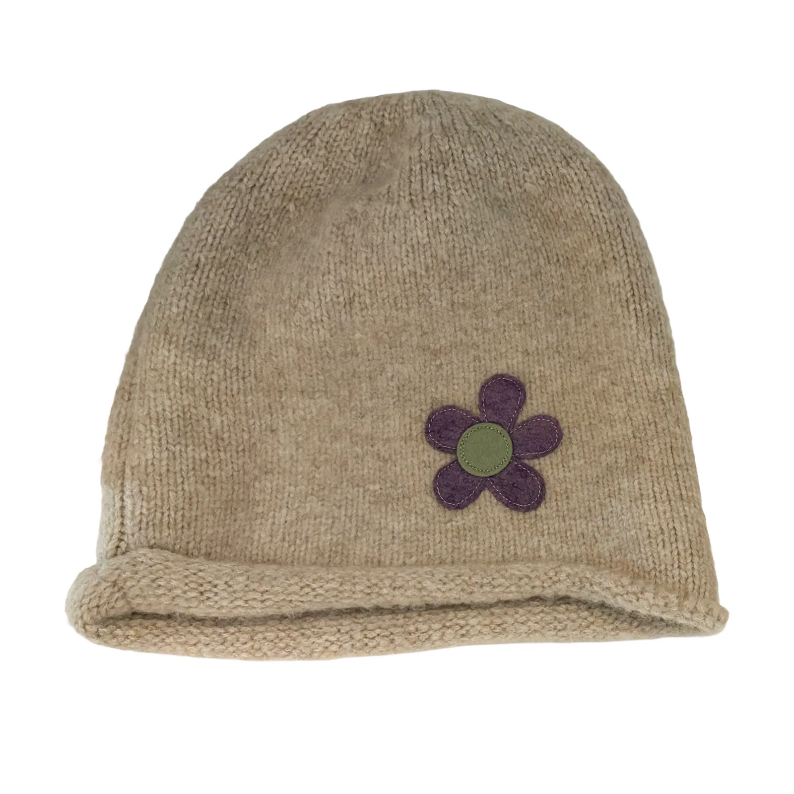 A beige knit beanie hat featuring a small embroidered flower applique on the front with purple petals and a green center, set against a plain white background.