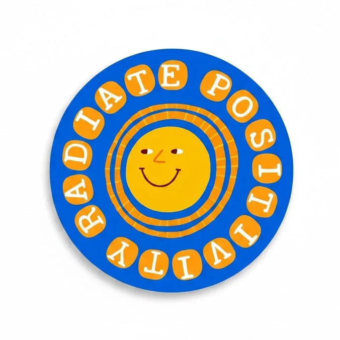 Be Kind Goods 3-inch circular vinyl sticker featuring a yellow sun face and the text Radiate Positivity in blue