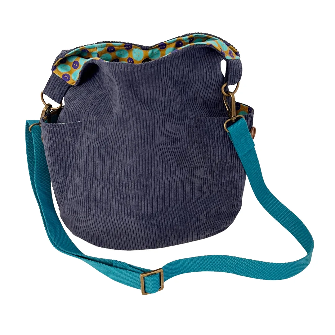 Blue corduroy bag with a retro lining on a white background