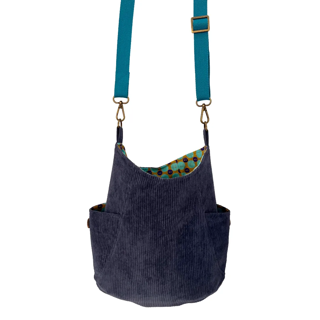 Blue corduroy bag with a patterned interior on a white background