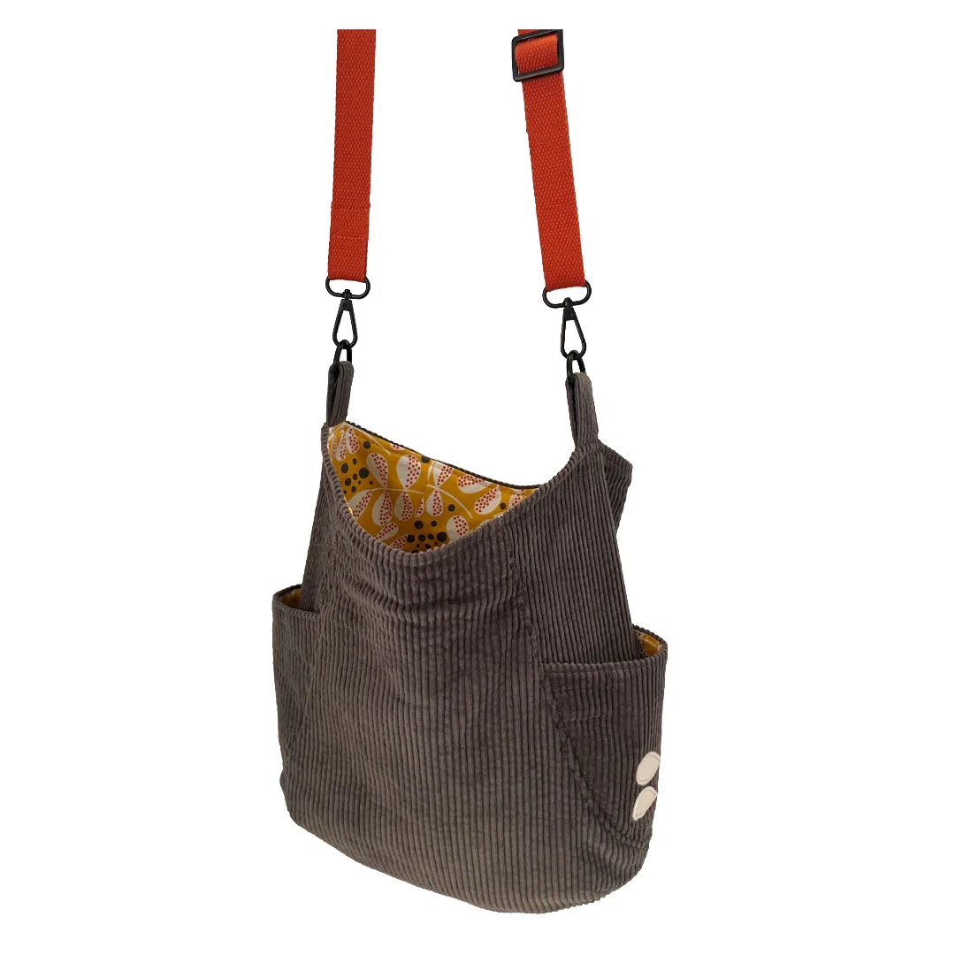 Gray corduroy bag with an orange strap on a white background