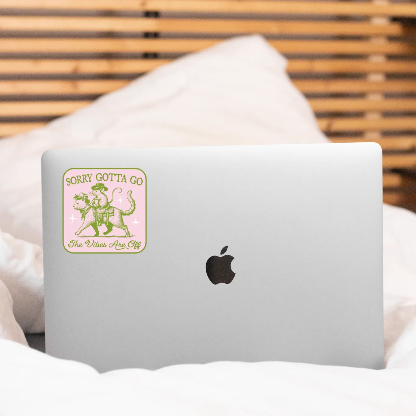 Laptop with a sticker on a bed