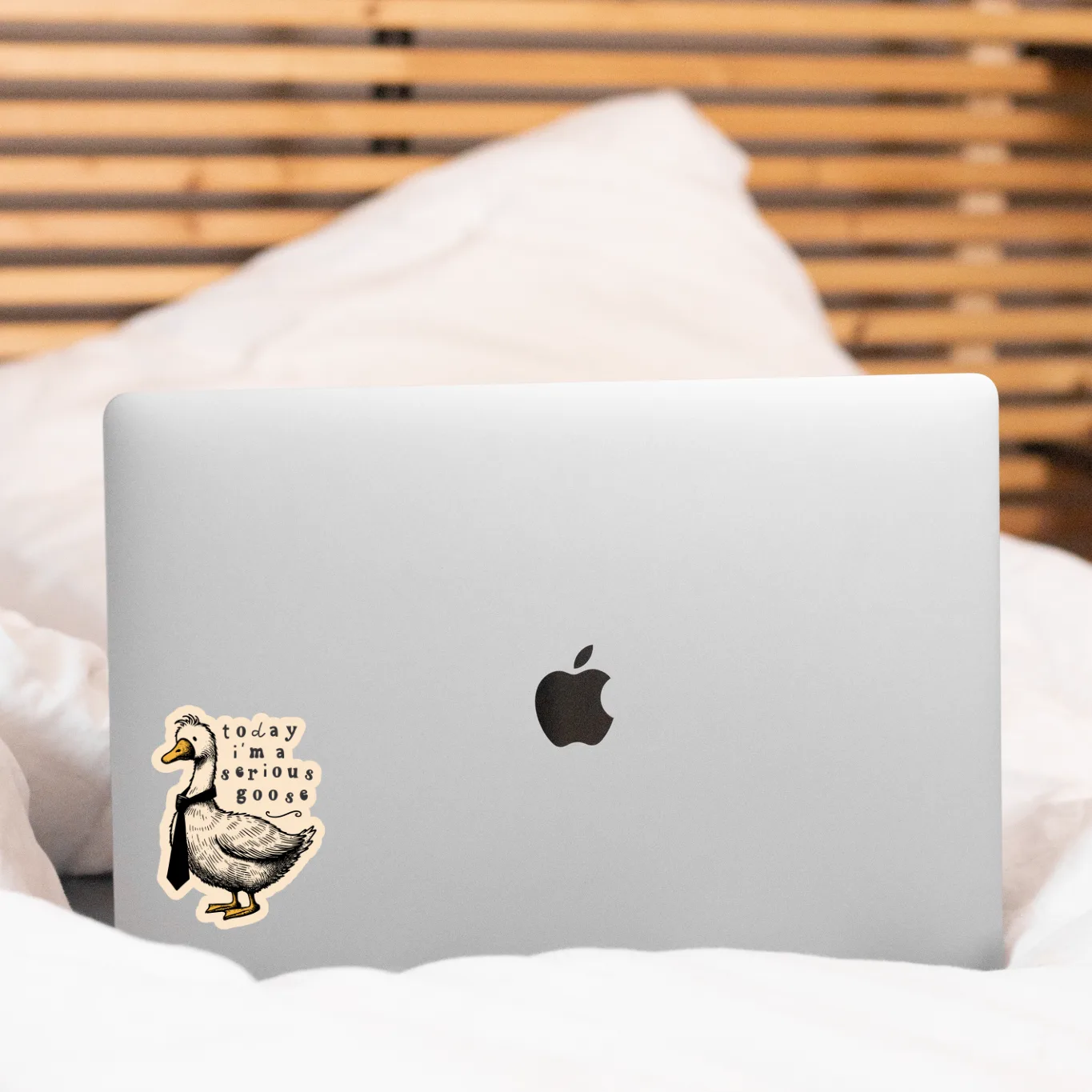 Laptop with a sticker on a bed