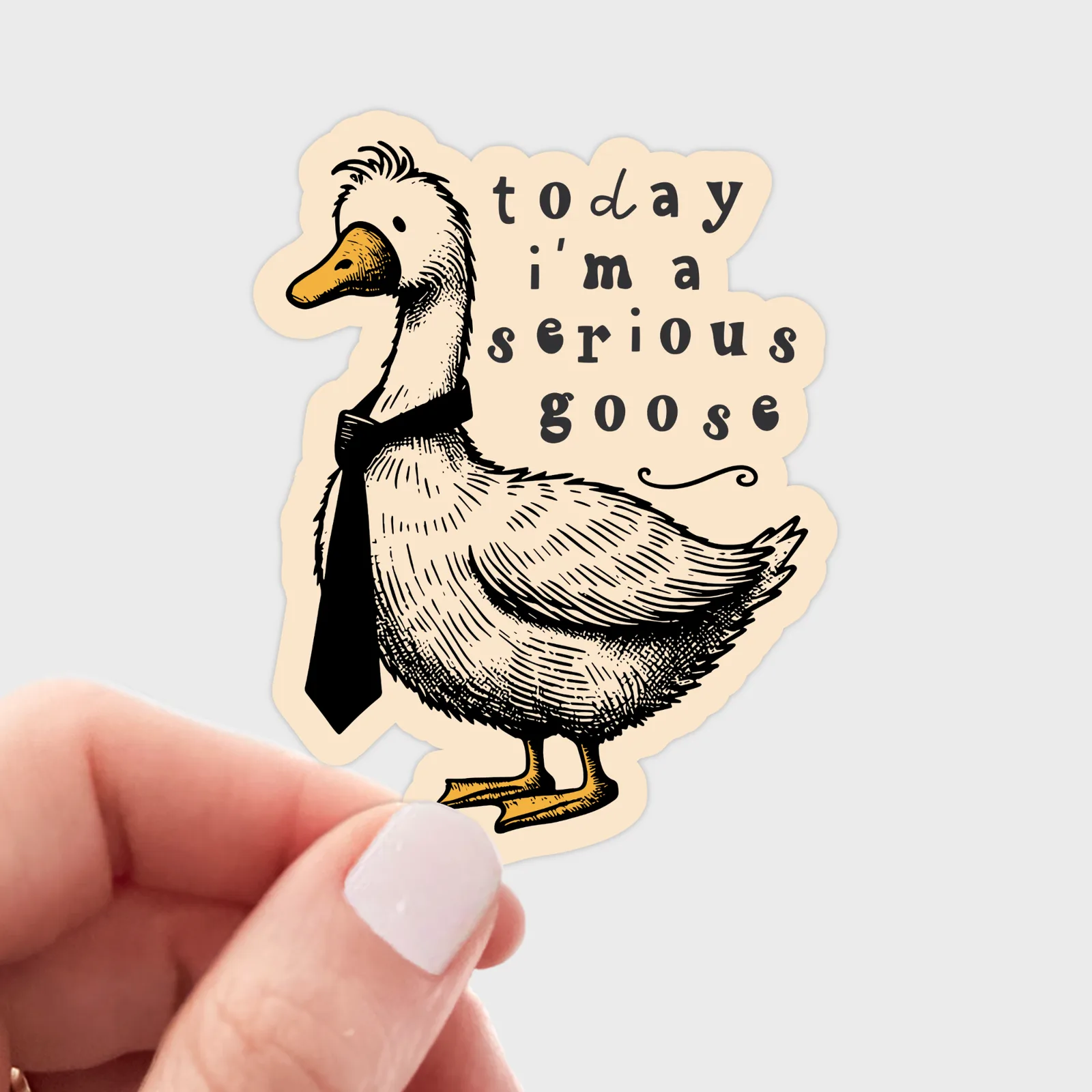 Sticker of a goose with text 'today i'm a serious goose' held by a hand on a light gray background