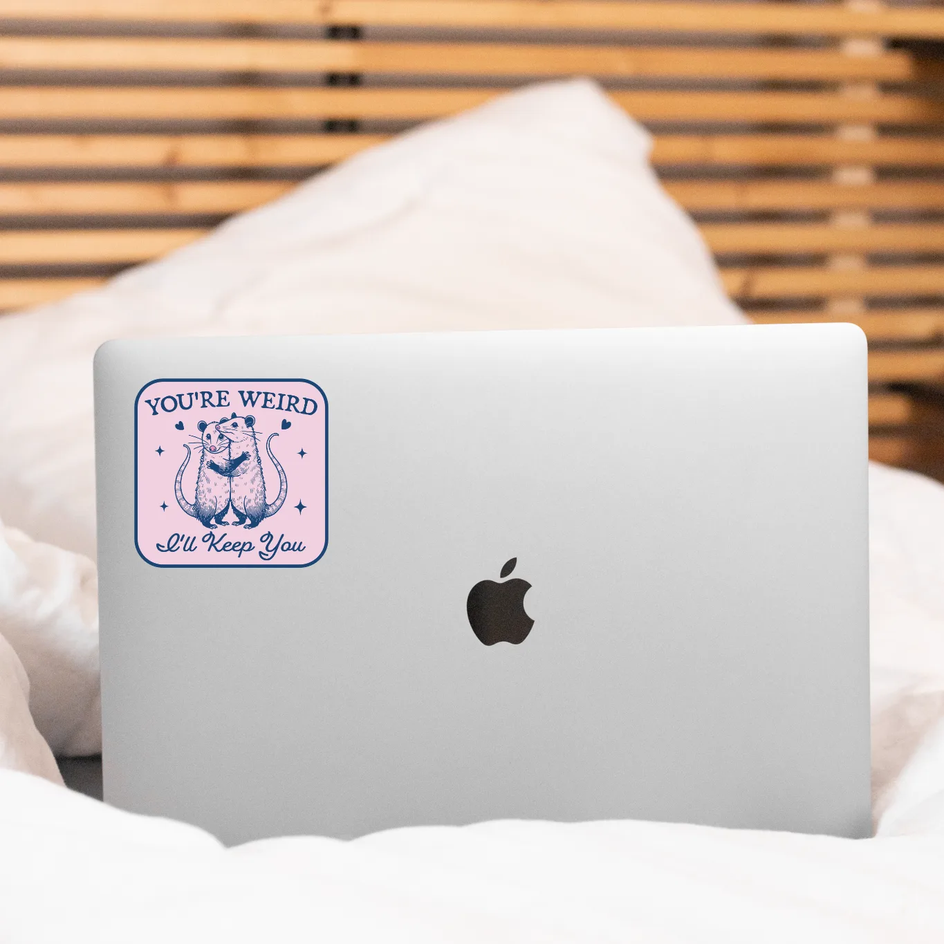 Laptop with a sticker on a bed