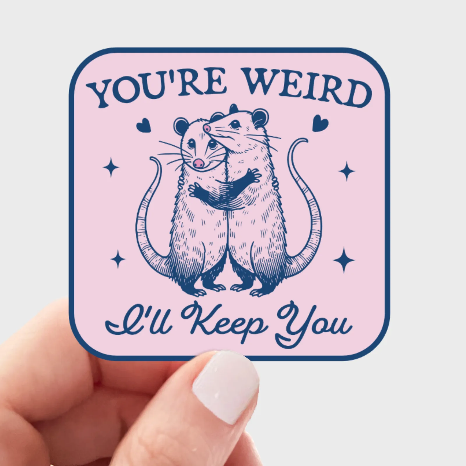 Sticker with two rats hugging and text 'You're Weird, I'll Keep You' on a pink background.